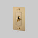 Gold light switch on a gray background