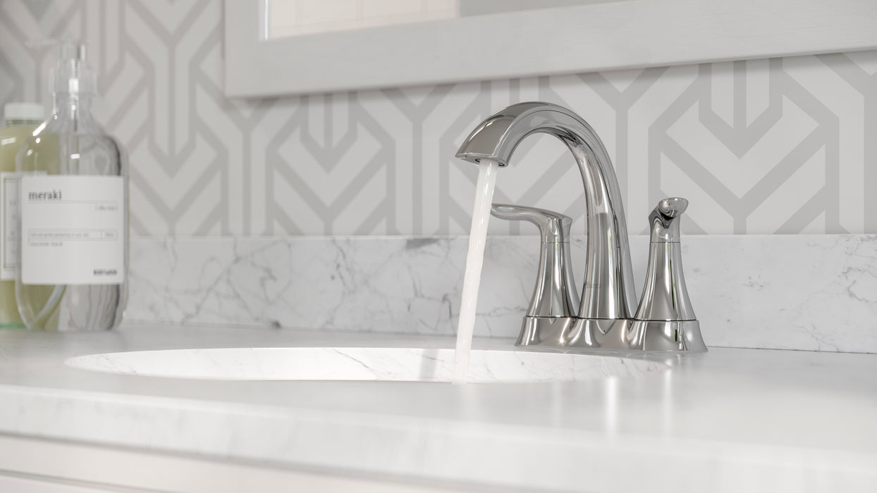 Pfister Weller 2-handle 4-inch centerset bathroom faucet in polished chrome, installed on a white countertop in a modern bathroom, with water flowing gently from the spout.