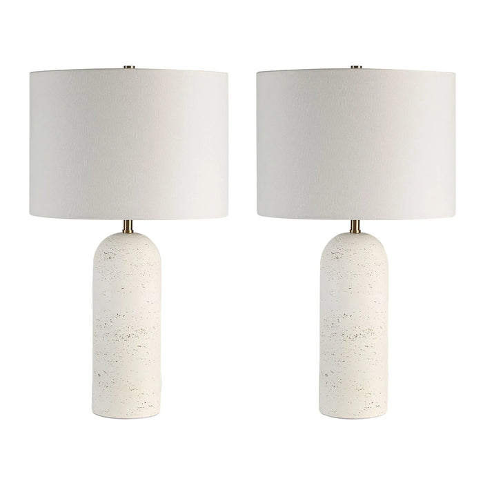 Two table lamps with white cylindrical bases and white lampshades on a white background