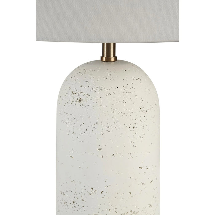 Table lamp with textured white base and beige lampshade on a white background