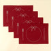 Four matching red Bon Appetit placemats arranged in an overlapping display with white embroidered place-setting designs