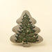 Indaba tree-shaped pillow with green evergreen embroidery, red accents and cream pom-pom details on natural fabric