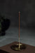 Upright incense stick in a holder against a dark background
