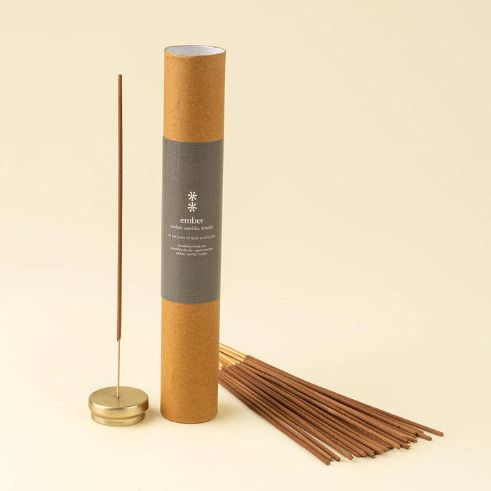 Ember incense set with a brown gift tube, bundled sticks, and one stick standing in the included holder