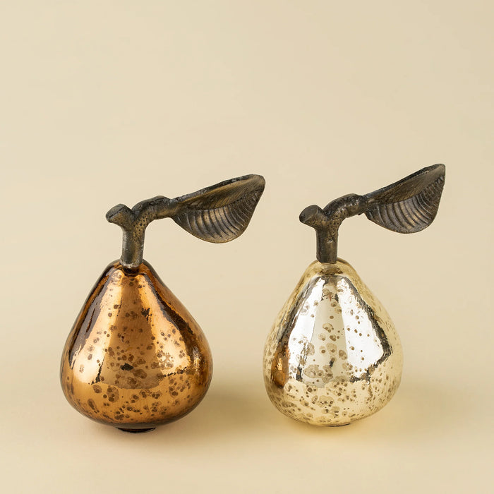 Bronze and silver-toned decorative glass pears displayed side by side with metal stems and leaves
