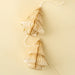 Close-up of ivory paper trees with layered folds and antique gold edges attached to a pale garland cord