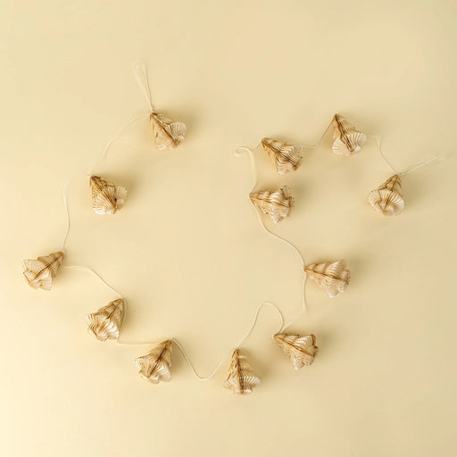 Indaba ivory paper tree garland arranged on a cream background, with folded trees spaced along a pale cord