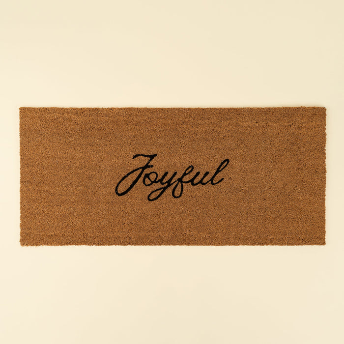 Indaba rectangular natural coir doormat with the word Joyful printed in black cursive lettering