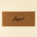 Indaba rectangular natural coir doormat with the word Joyful printed in black cursive lettering