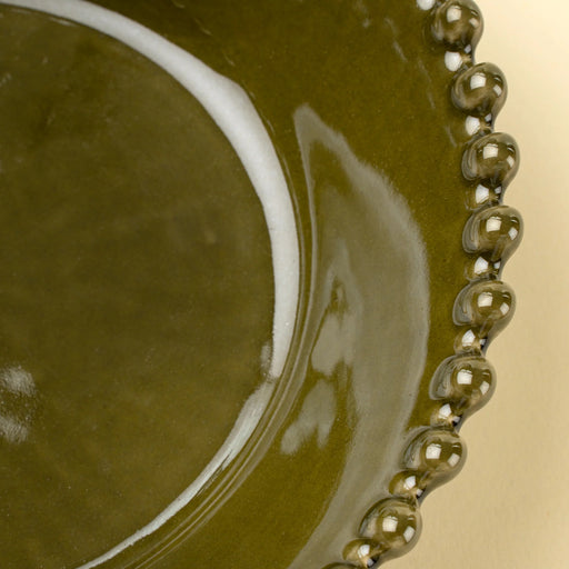 Close-up of the glossy green interior and rounded hobnail edge on an Indaba Merida soup bowl