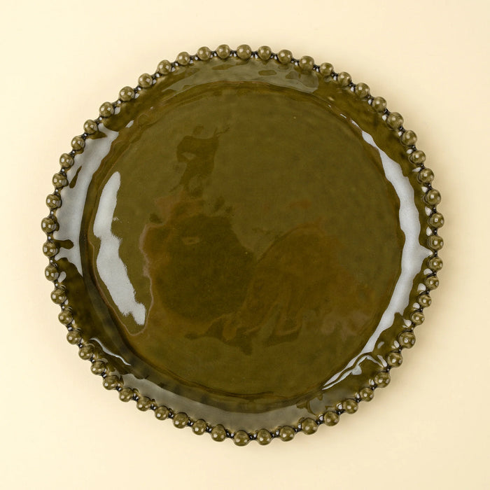 Top view of an Indaba Merida green stoneware dinner plate with a glossy glaze and hobnail rim