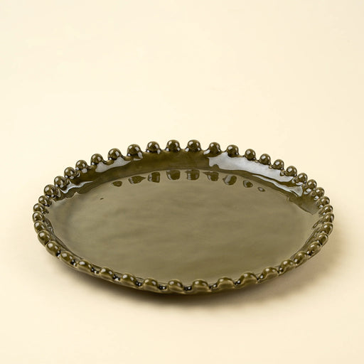 Merida salad plate viewed from above, with an earthy green centre framed by a raised beaded edge