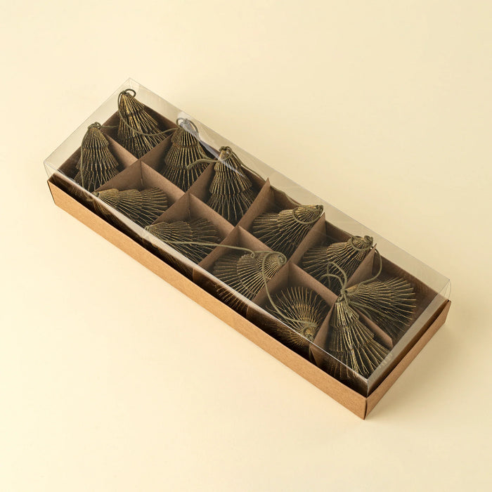 Green paper tree garland neatly arranged inside a long rectangular gift box