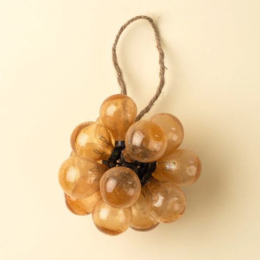 Indaba peach bubble bunch ornament with rounded glass droplets, dark metal fittings and a natural twine hanging loop