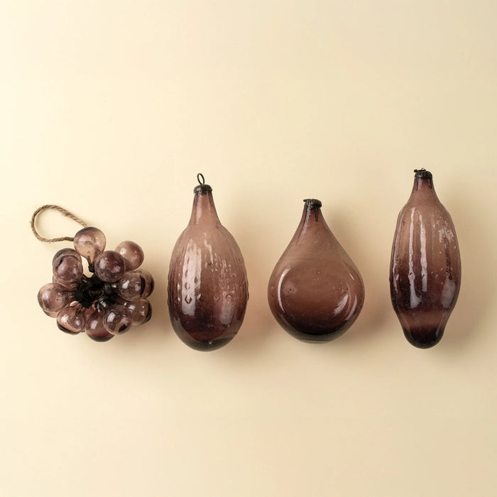  Plum bubble bunch ornament displayed beside three teardrop-shaped glass ornaments on a cream background