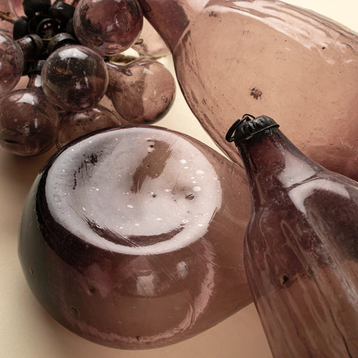 Close-up of plum glass decorations showing the bubble cluster alongside rounded and elongated glass forms