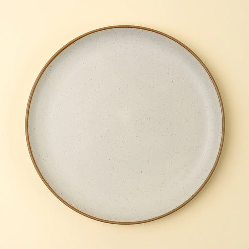 Top view of an Indaba Rowe ivory dinner plate showing its round shape and speckled glaze