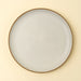 Top view of an Indaba Rowe ivory dinner plate showing its round shape and speckled glaze