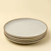 Four stacked Indaba Rowe ivory stoneware dinner plates with contrasting unglazed rims