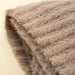 Close-up of the Tuffet Snug Throw showing its soft fibres, knitted texture and finished edge