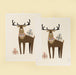 Two cream cotton tea towels featuring brown stags with black antlers and wrapped gifts