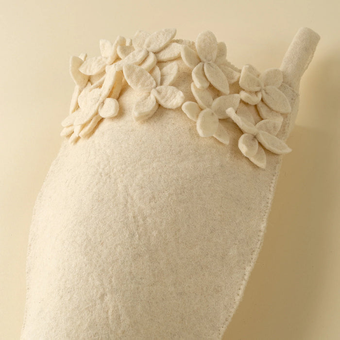 Dimensional felt petals clustered around the Winter Bloom stocking cuff above its softly textured wool-blend body