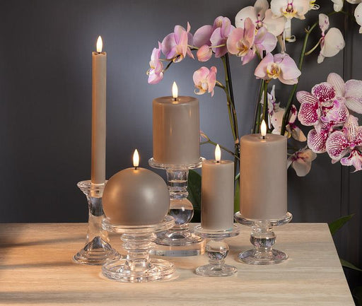 Luxlite Moon Grey flameless LED candles displayed on a table with flowers