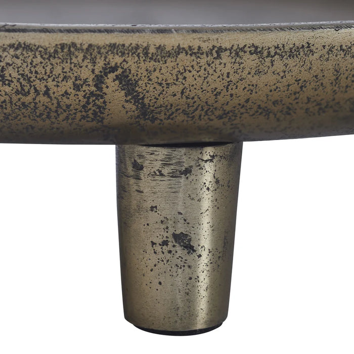 Close-up of the Kaleido tray’s textured antique brass finish and metal leg