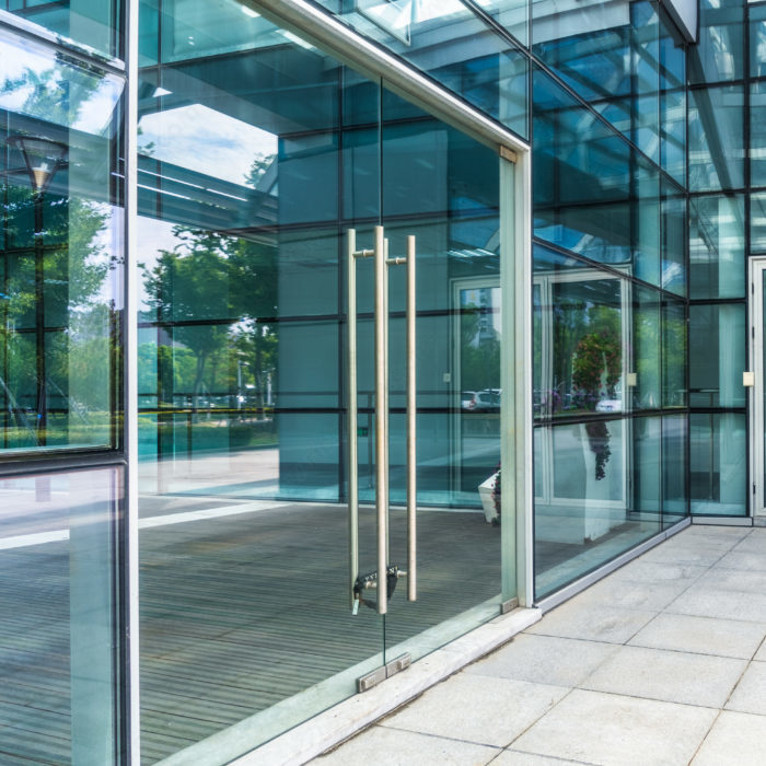 Richelieu stainless steel ladder pull handle installed on a glass door
